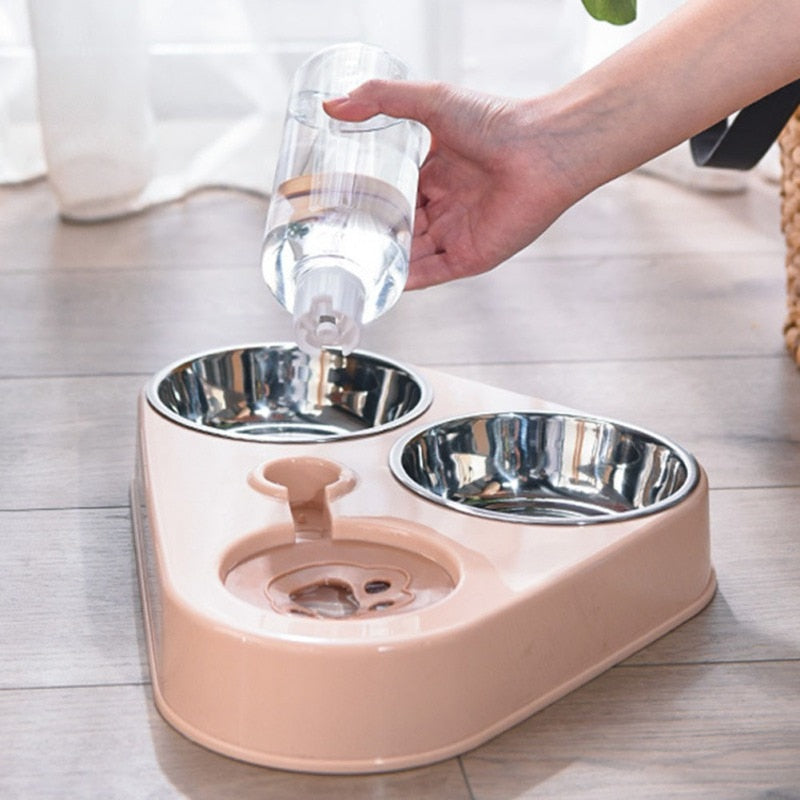 Pet water fountain with two bowls on a light wooden floor.