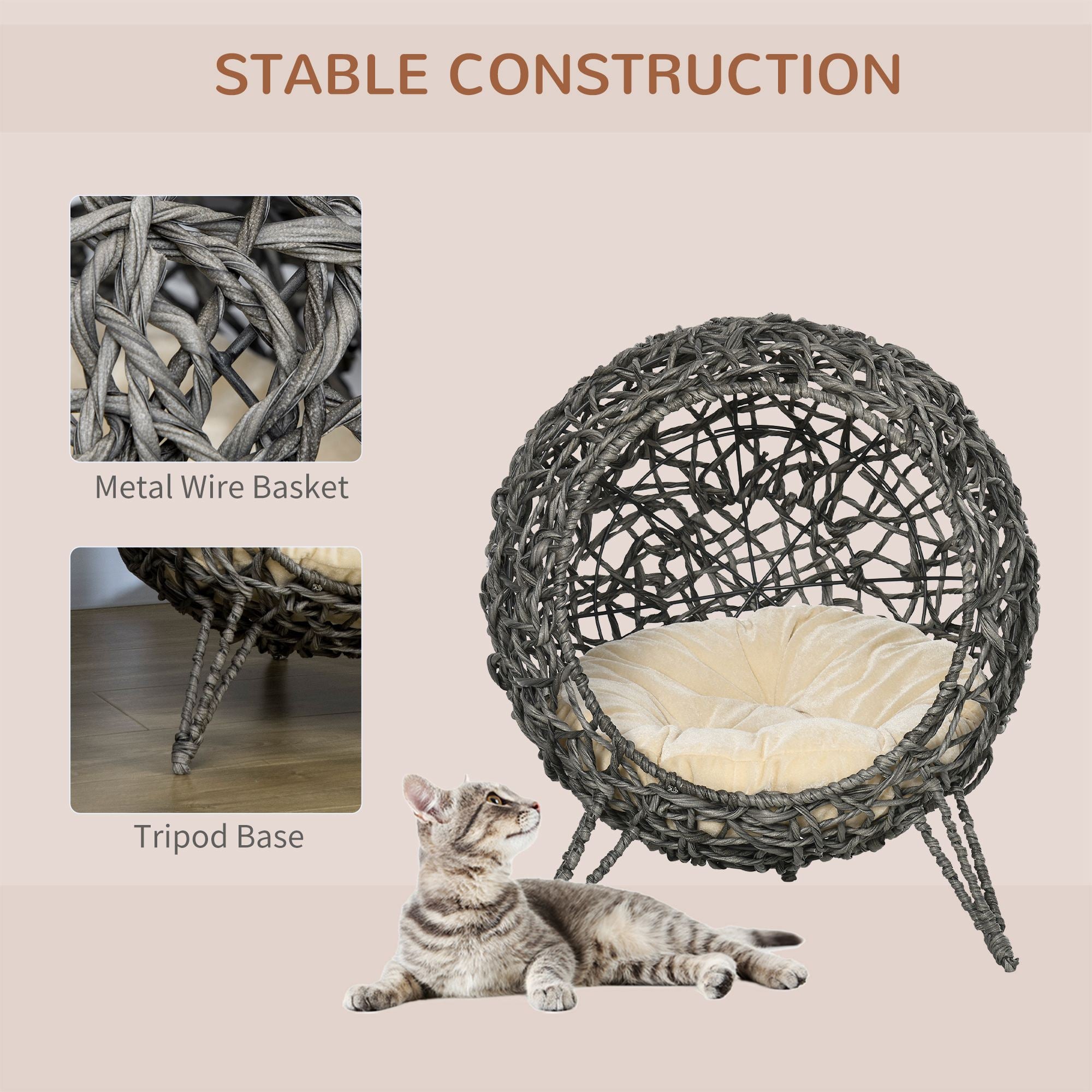 Wicker pet bed with metal wire basket and tripod base, featuring a cat for scale.