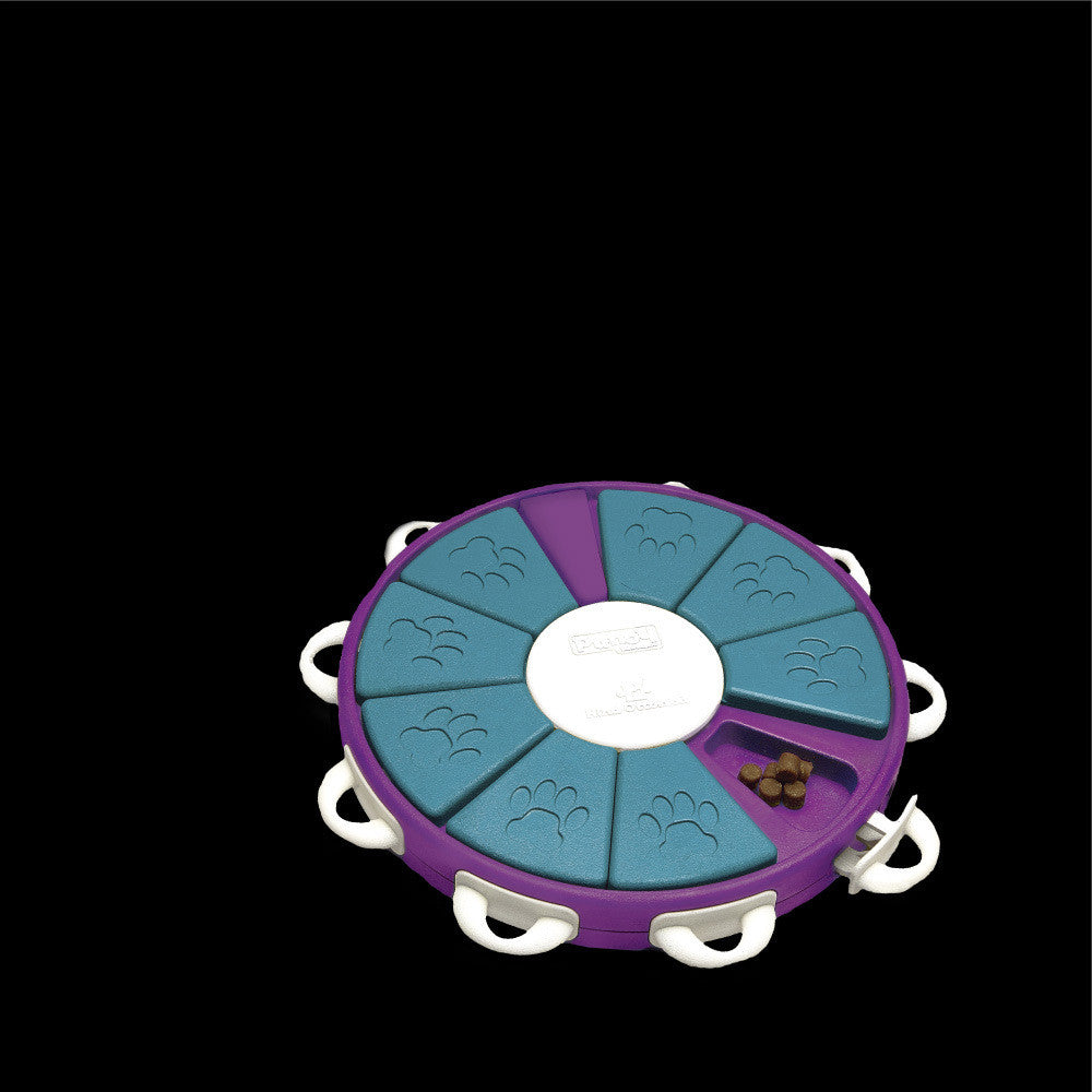 Round pet toy with multiple compartments on a black background