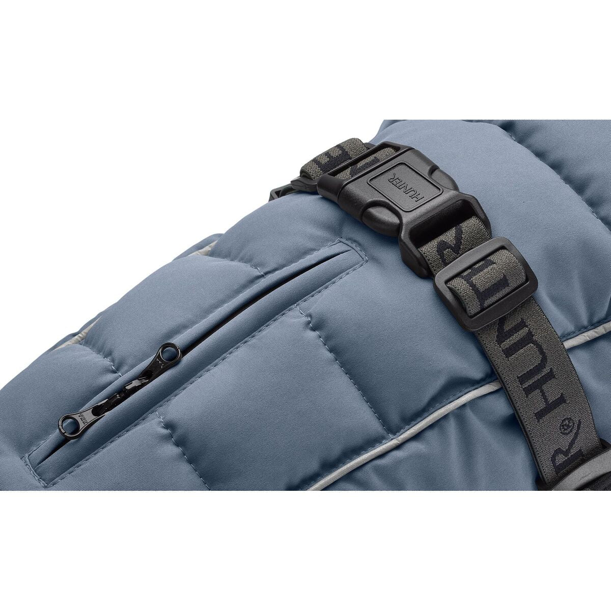 Close-up of a blue backpack with a black strap and visible brand logo.