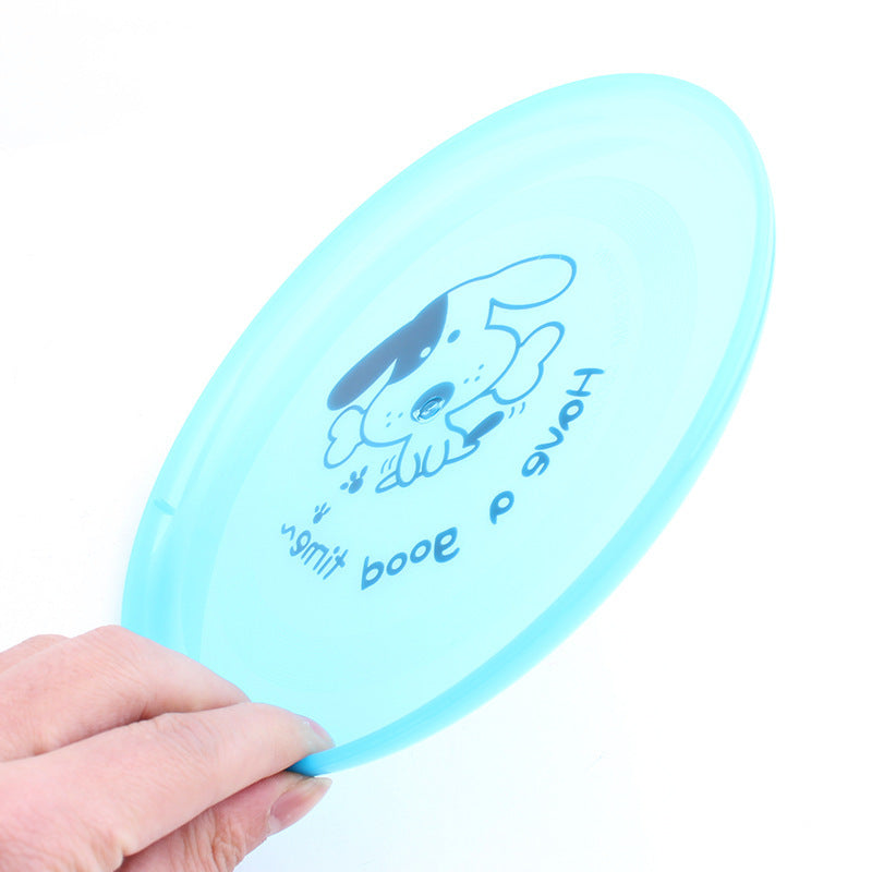 Light blue frisbee with a dog illustration and text held by a hand on a white background