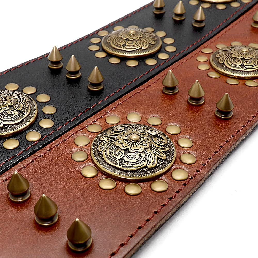 Decorative leather belt with gold studs and metal plates on a white background