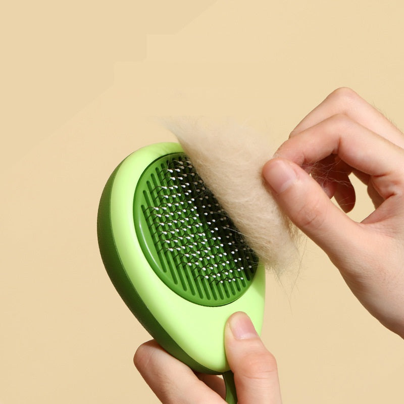 Green pet grooming brush with fur on a beige background