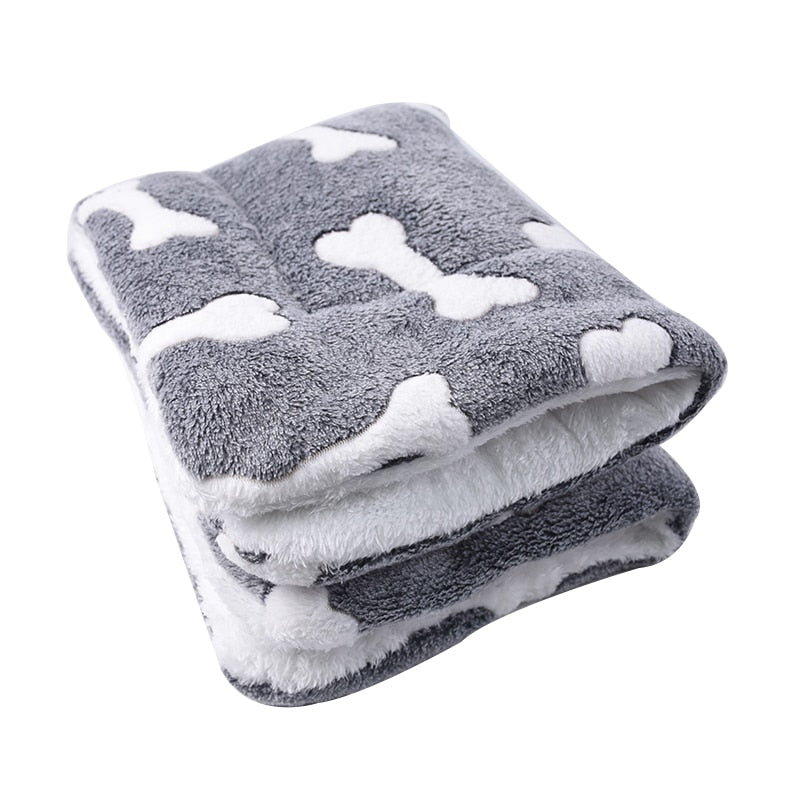 Gray pet blanket with white paw prints on a white background