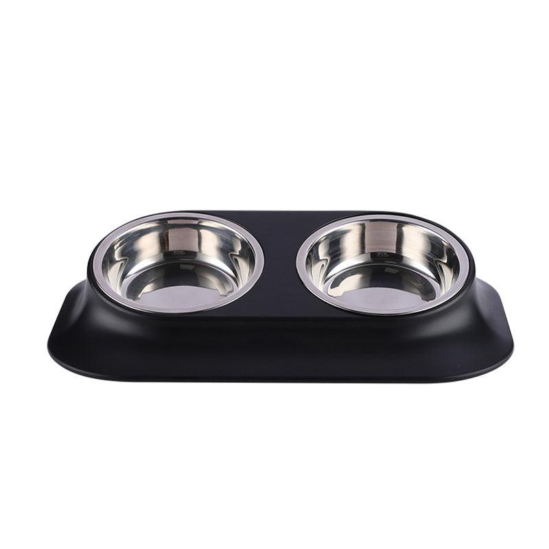 Black pet feeder with two stainless steel bowls on a white background