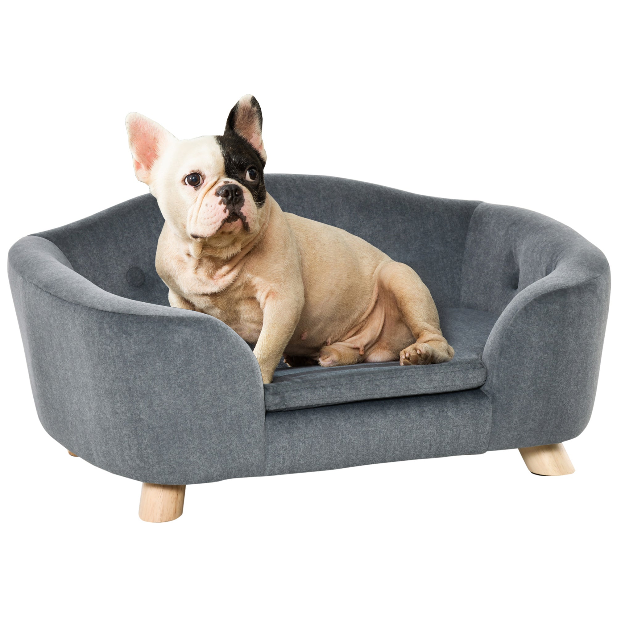 Dog sitting on a gray pet bed with wooden legs against a white background