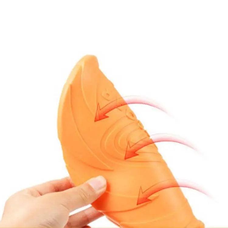 Orange carrot-shaped product with a hand holding it on a white background