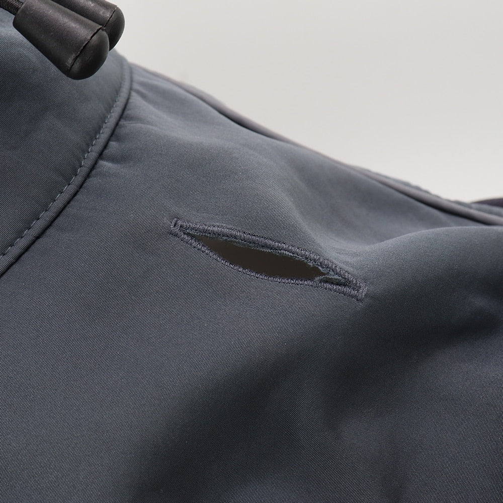 Close-up of a gray jacket with a pocket detail on a light gray background