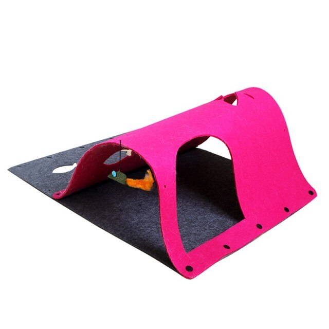 Pink pet playpen with a gray mat and toy on a white background