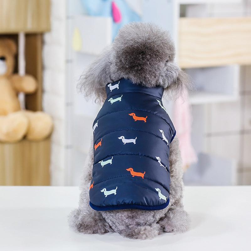 Dog wearing a navy blue puffer vest with dog pattern indoors