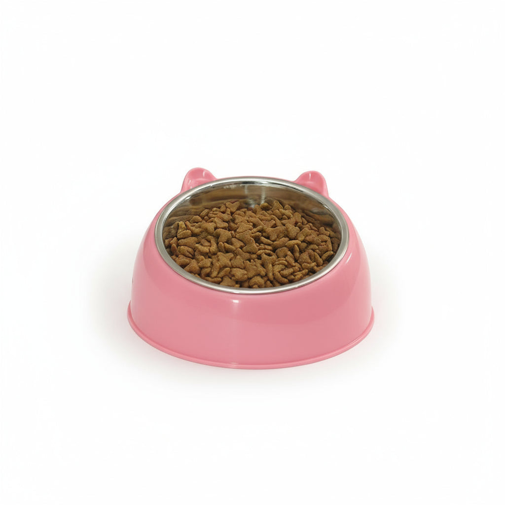 Pink pet bowl with kibble on a white surface