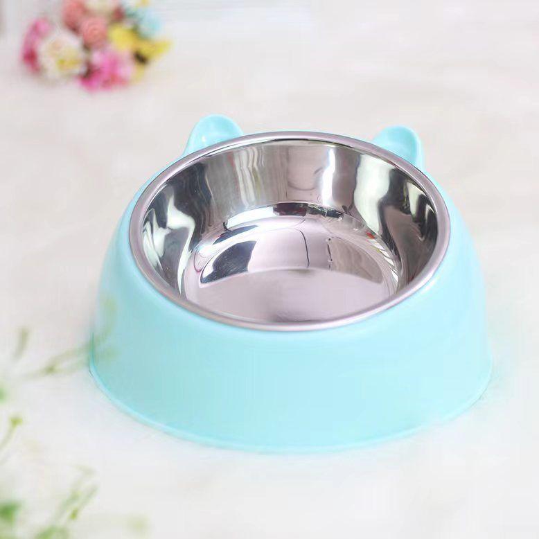 Blue pet bowl with a stainless steel interior on a light background